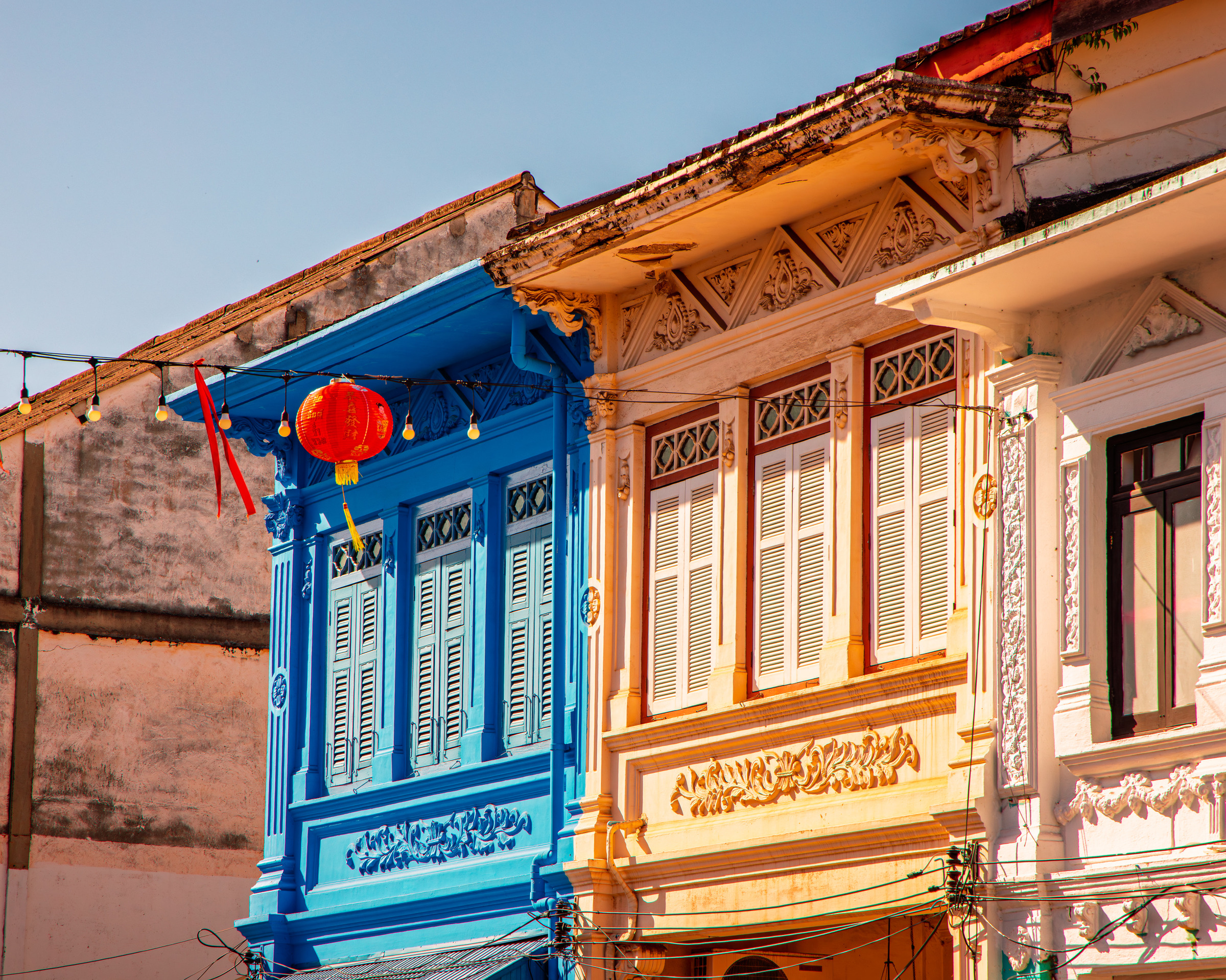 Blue and cream colonial building detail with red lantern, Sino-Portuguese architecture — architectural photography