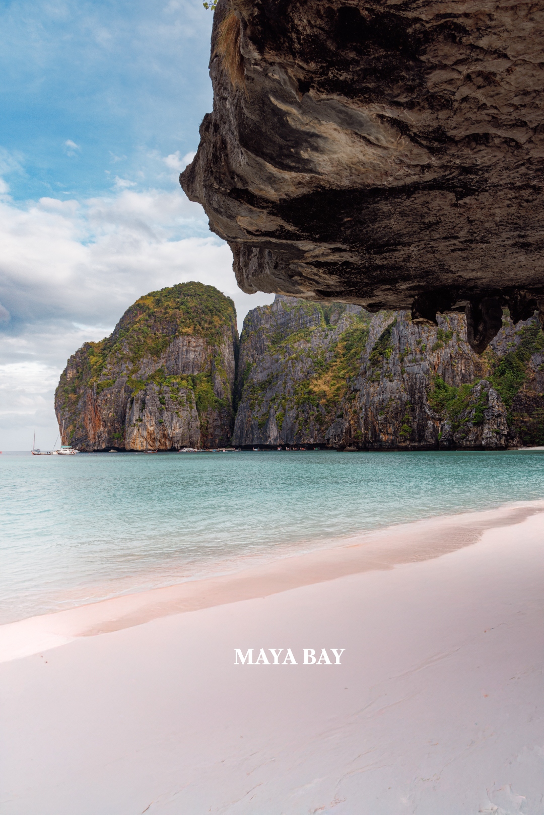 Maya Bay from beneath a rock overhang with pink sand, Phi Phi Islands — landscape photography by Samuel John Ford