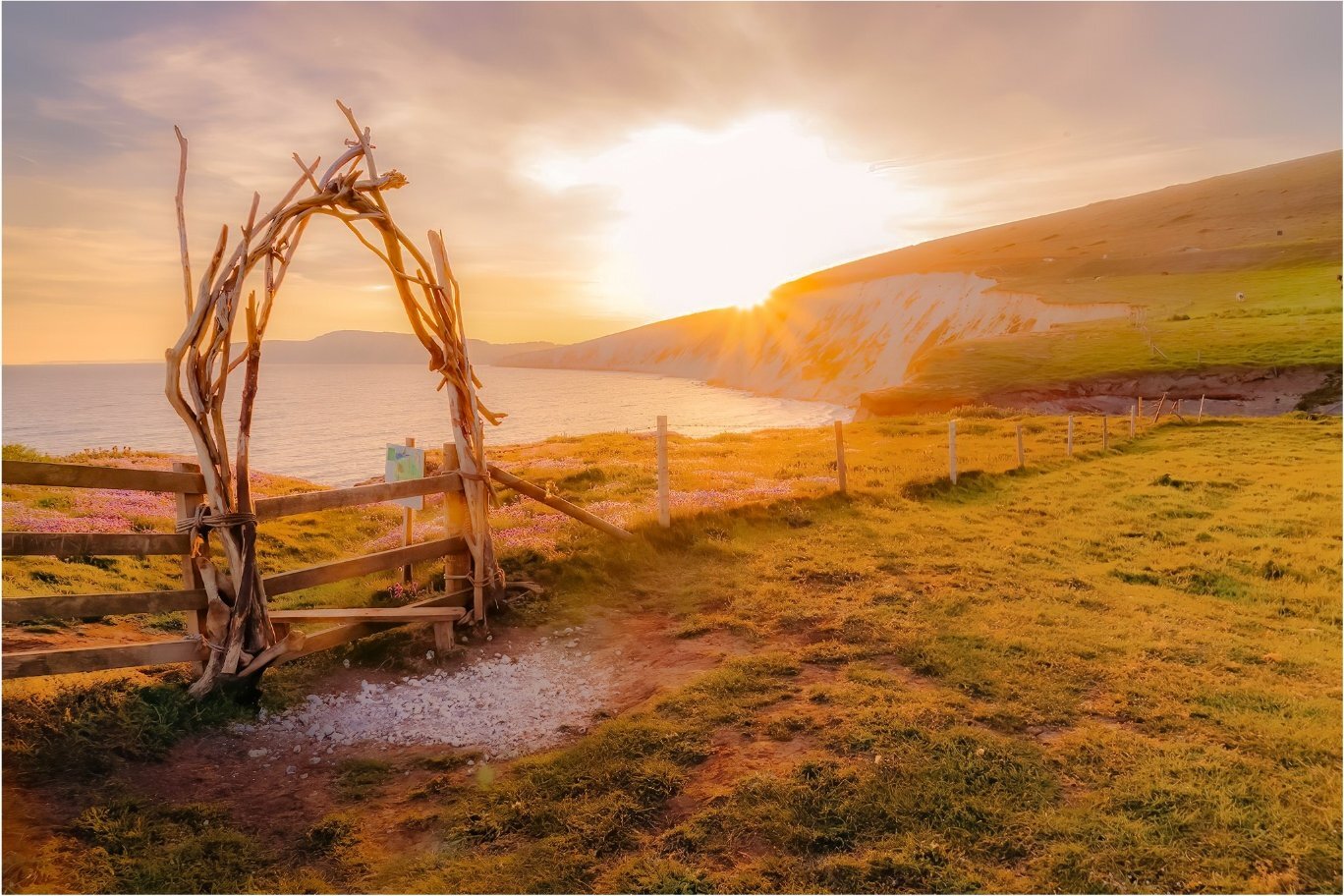 Driftwood arch gate at golden sunset, Isle of Wight