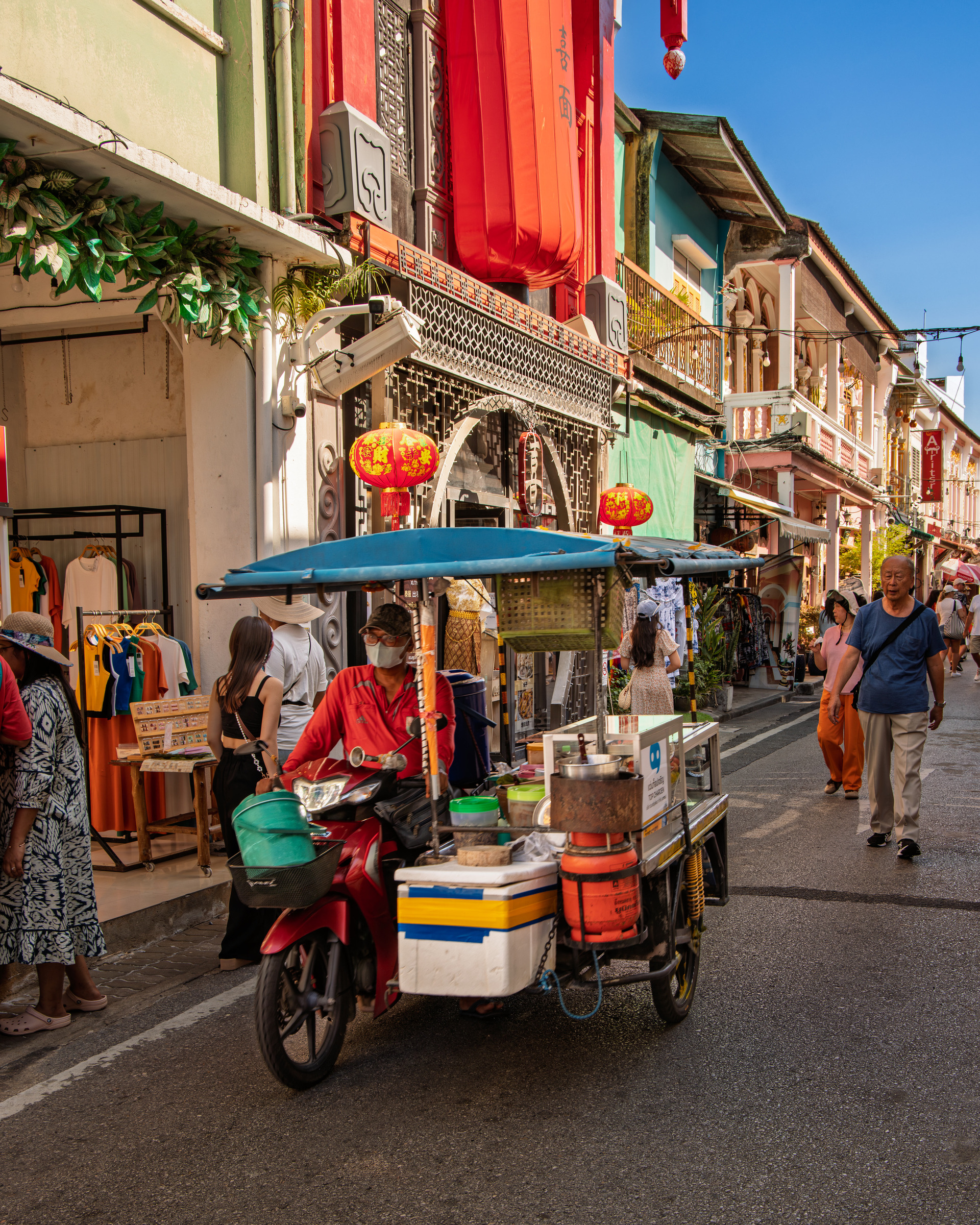 Street food vendor on motorbike with colourful shophouse facades, Phuket Old Town — street photography by Samuel John Ford