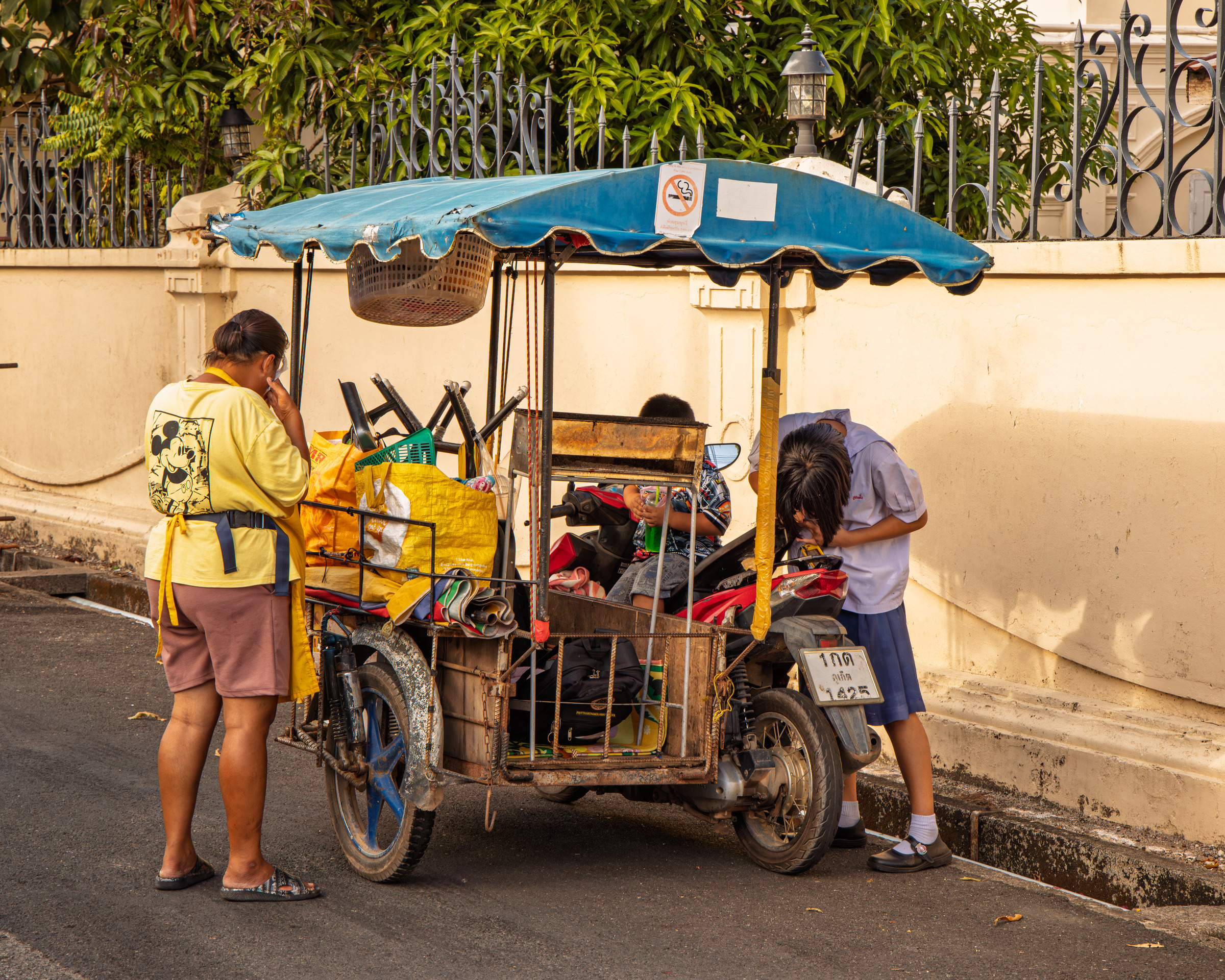 Woman and schoolgirl at a street cart, Phuket Old Town — documentary travel photography
